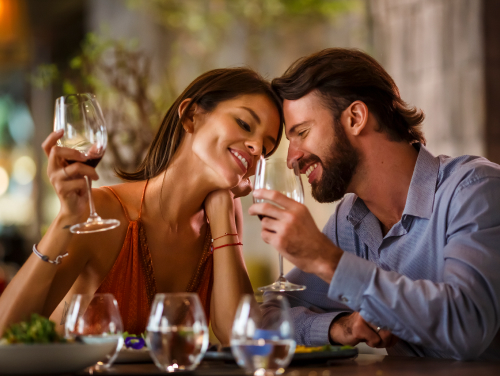 Romantic couple savoring wine at Grand Velas Resorts