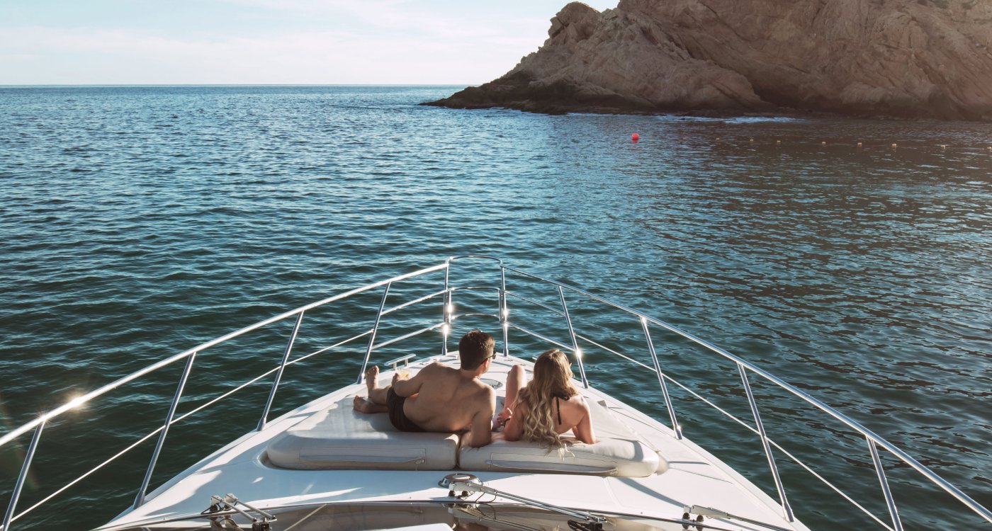 A scenic view of a couple on a boat near Grand Velas Los Cabos