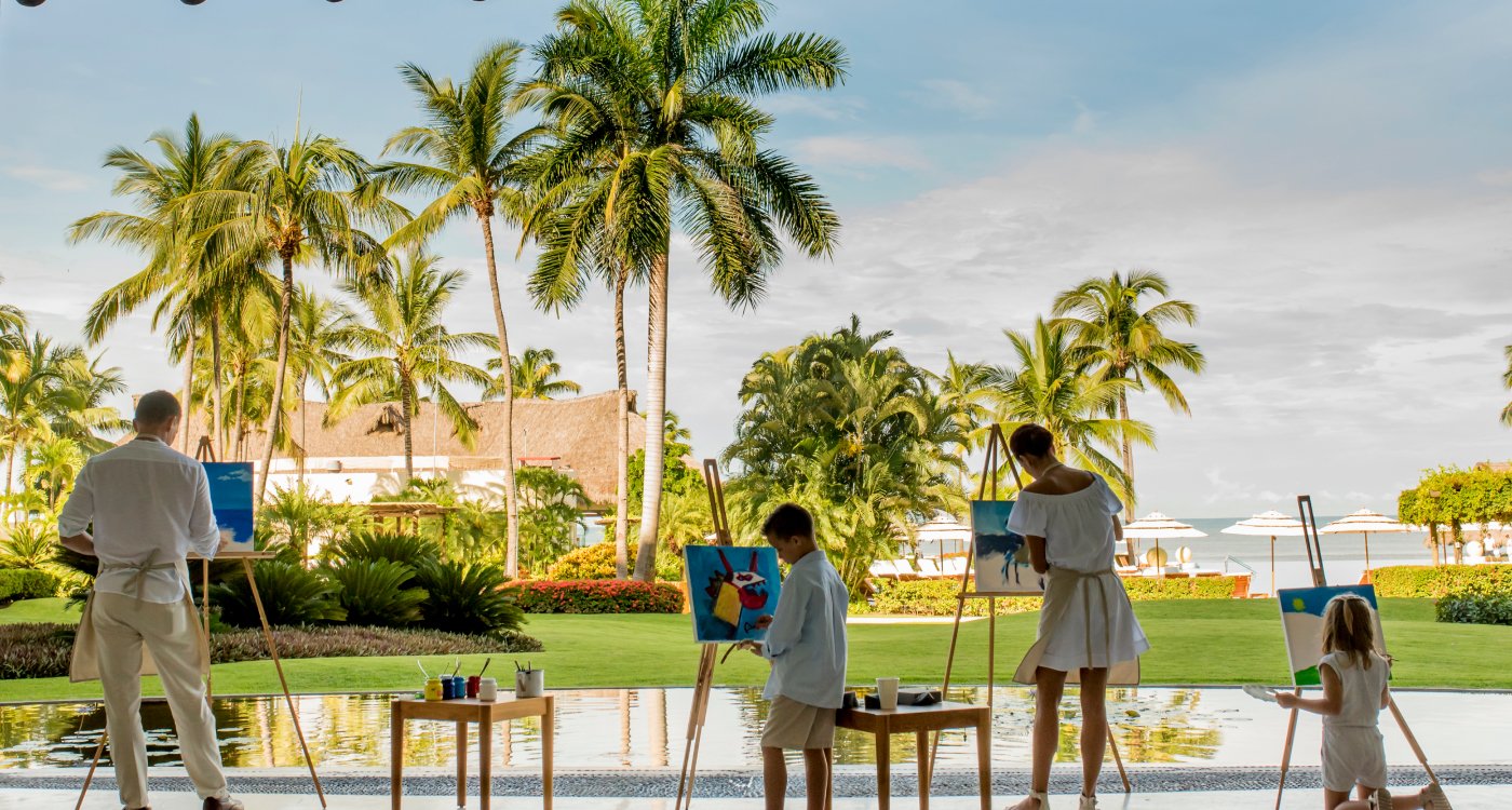 Family painting by pool at Grand Velas Riviera Nayarit